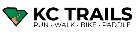 KC trails logo letters in black with Run, WAlk, Bike, Paddle underneath the bold KC Trails heading with an outline of South Carolina filled in with green with a brown trail winding through.