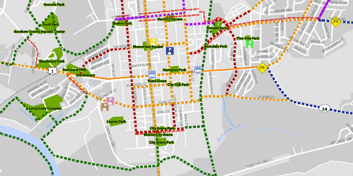 Map showing city streets, parks, and routes marked with red, green, purple, orange, and blue dashed lines.