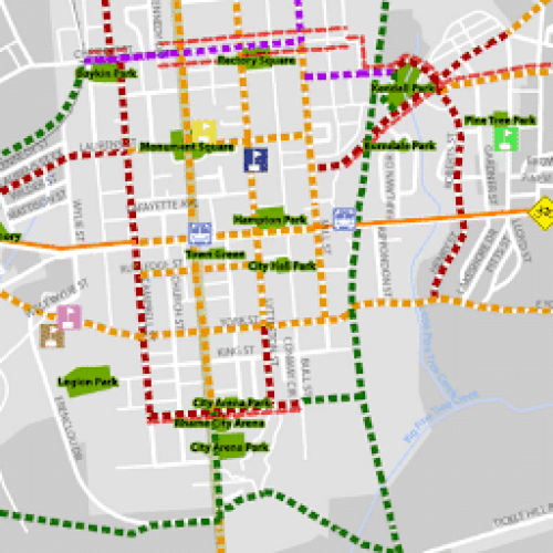 Map showing city streets, parks, and routes marked with red, green, purple, orange, and blue dashed lines.