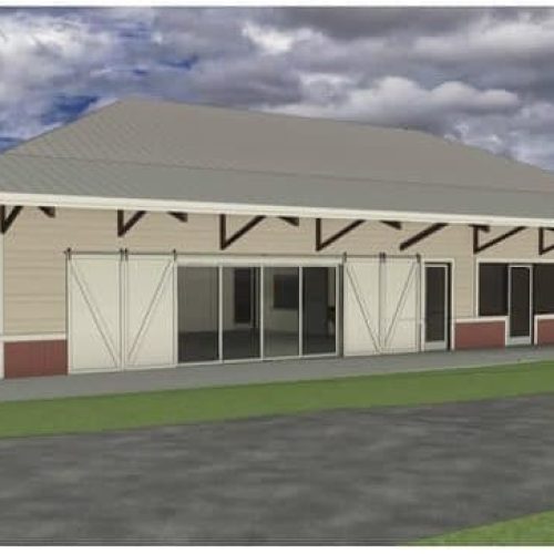 A modern, single-story building with a large overhanging roof and barn-style sliding doors.